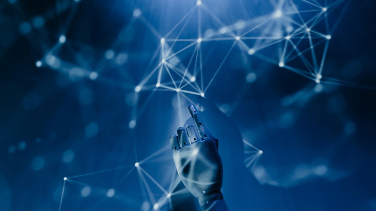 Hand reaching into abstract artificial intelligence network