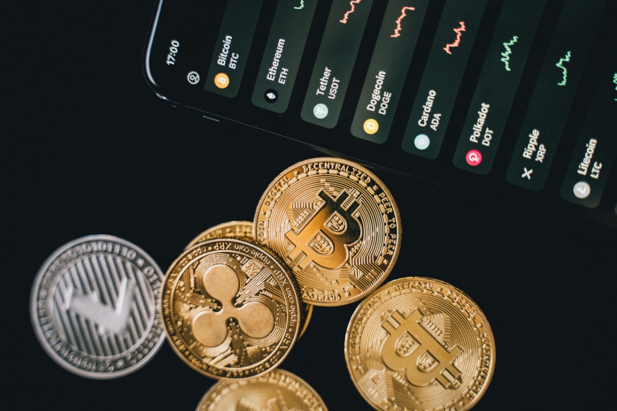 Cryptocurrency coins and trading screen, digital asset legal support