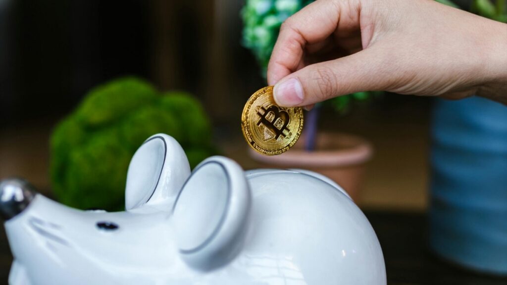 Bitcoin being placed in a piggy bank